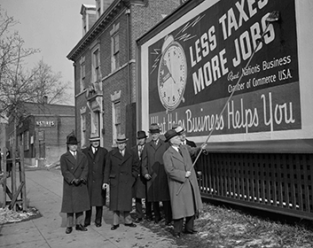 monochrome image describing the great depression in which a man points to a banner